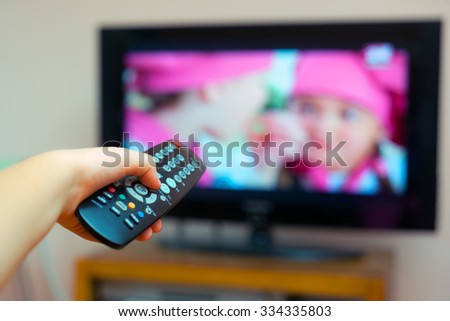 Kid holding TV remote controller