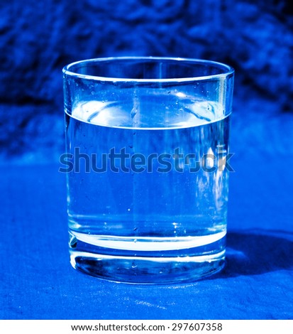 The carafe with clean water on a blue background