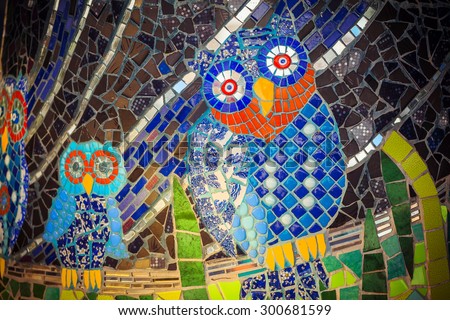 Painted stone owl on a palette. Owl pattern mosaic