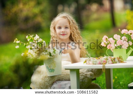 Little girl helping with flowers in the garden