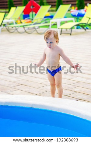 Cute kid ready to jump into the swimming pool