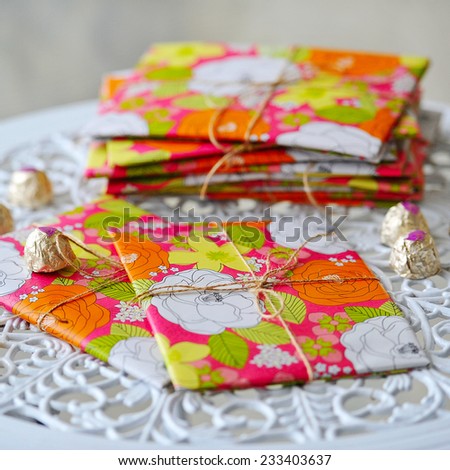Beautifully styled and wrapped presents and sweets on white lace table cloth