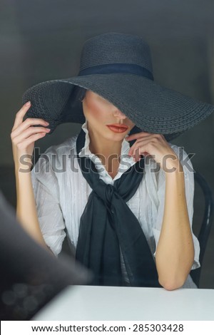 Portrait of a beautiful woman wearing black floppy hat