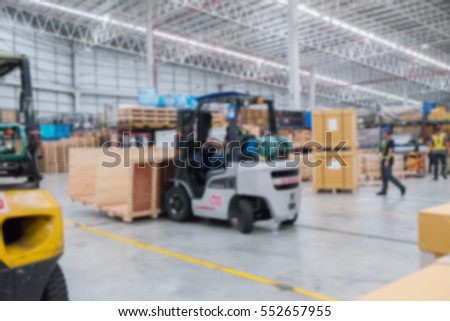 Blurred huge distribution warehouse and cardboard boxes on pallet.  freight transportation and delivery concept.