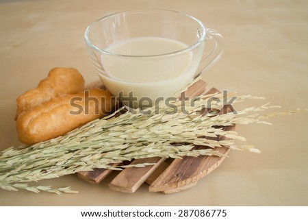 soybean milk with deep-fried dough stick on wood plate