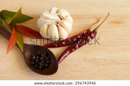 Thai similar : Galic, Chilli red dried pepper, and black peppercorn on wooden table