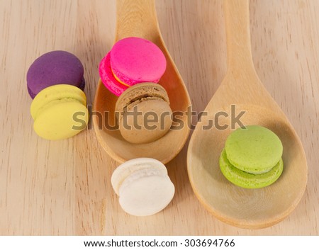 colorful macaron on wood plate and wood spoon
