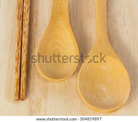 Wooden spoon , ladle and chopsticks on wooden table in kitchen.