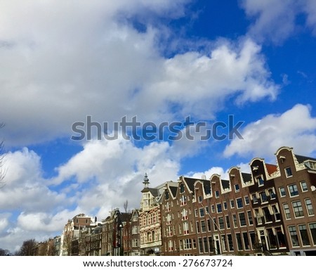 Clouds over Amsterdam architecture.