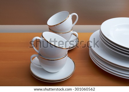 white plates, gold trim white cups & saucers