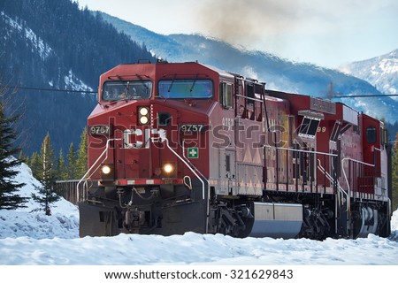 Banff, Canada - March 18, 2014: Canadian Pacific train with Canadian Rockies in the background in winter