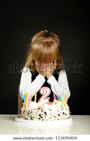 little girl with birthday cake make a wish
