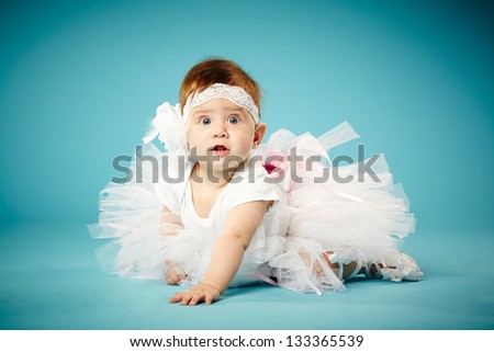 cute little ballerina on blue background