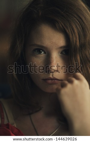 portrait of a beautiful red haired girl with freckles
