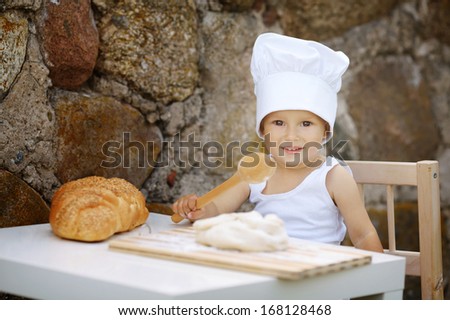 cute little boy with chef hat cooking