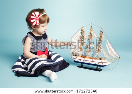 cute girl sailor with model ship