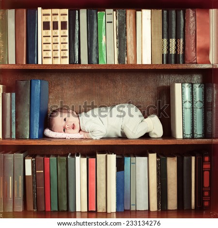 baby lying on book shelf in bookcase
