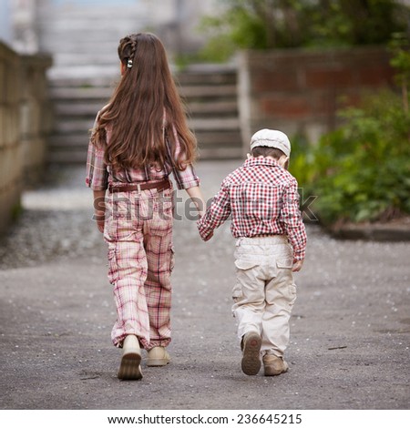 boy go with his pretty sister for the walk
