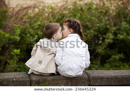 pretty child fell lovely and happy it`s  first kiss