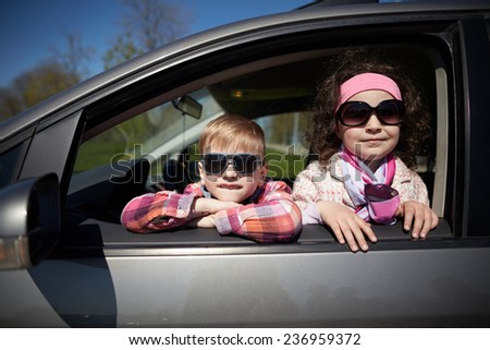 girl and boy driving fathers car