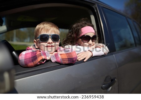 girl and boy driving fathers car