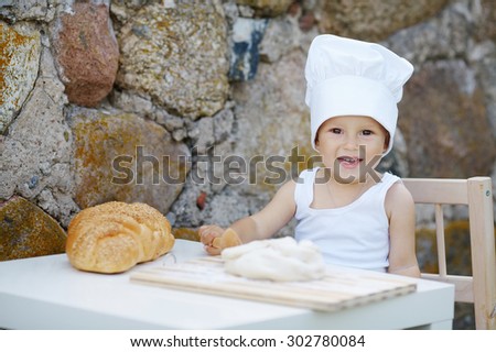 cute little boy with chef hat cooking