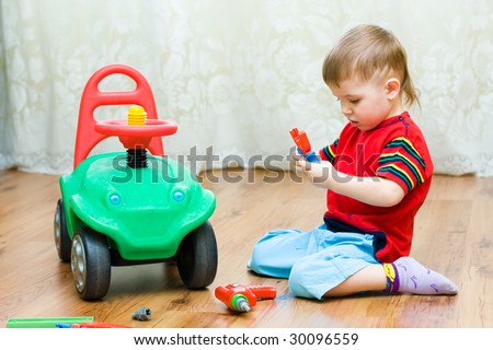 little boy repairs auto