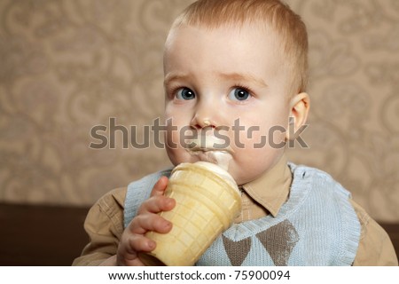 stock photo little beautiful boy eats icecream