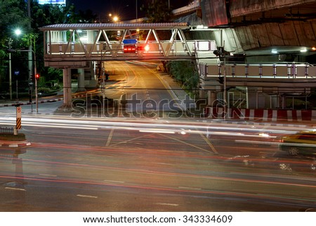 crossroad night speed light in bangkok , thailand