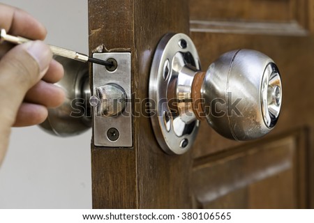 closeup of locksmith on old wood door , repair