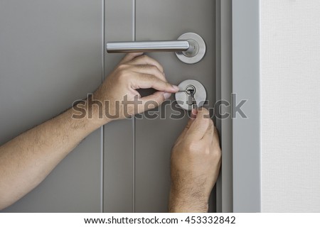 locksmith try to fix a key lock door for open it by screwdriver and tools - can use to display or montage on product