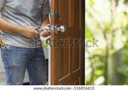 locksmith open the wood door by cylinder tools to green bokeh light - can use to display or montage on product