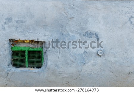 Grey old concrete wall with green window at the bottom left. Backgrounds, Wall, Textured, Gray, Stone Material