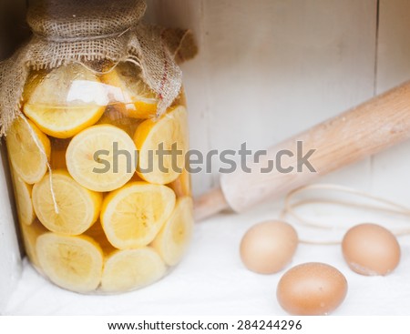 Preserved and Pickled lemon, eggs, rolling pin and corolla mixing, close-up