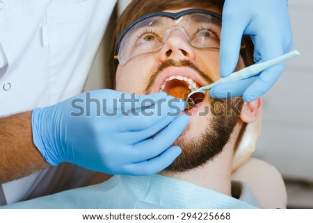 Close-up medical dentist procedure of teeth examination
