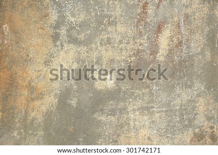Vintage, old, battered painted gray wall, with beige and brown spots on it, background texture, close up
