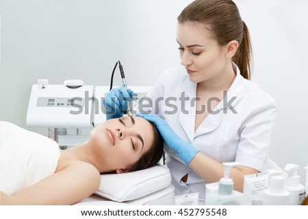 Procedure of Microdermabrasion. Mechanical Exfoliation, diamond polishing. Model and doctor. Cosmetological clinic. Healthcare, clinic, cosmetology