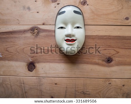 Traditional japanese theater masks made of iron on wood background