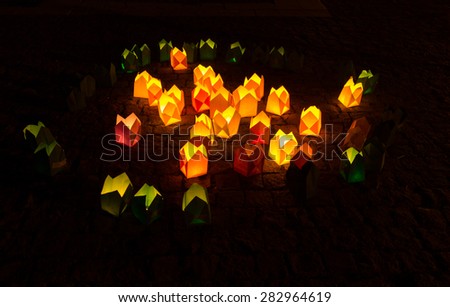Bright yellow and green candle lights in the dark