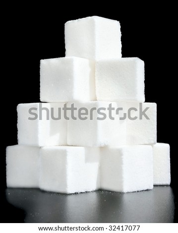 Pieces of sugar on a black background.