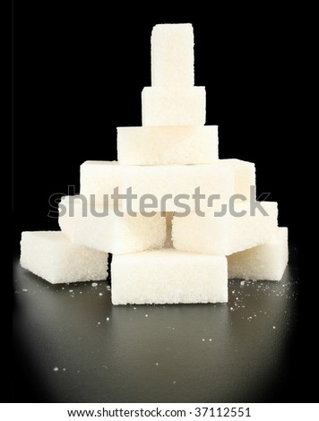 Pieces of sugar on a black background.