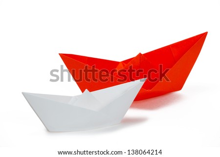 White and red paper ships on a white background