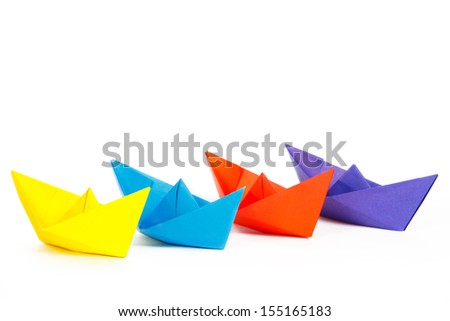 Four colored paper ship on a white background