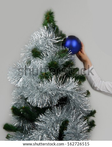 child dresses up Christmas tree