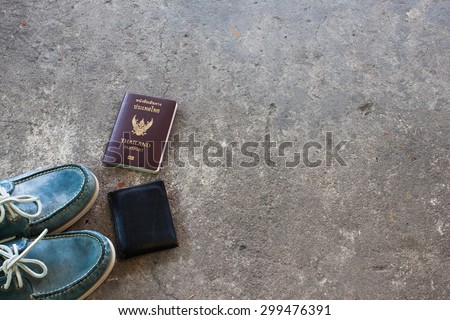 Shoes on the cement floor. and passport ready to go travel.wallet.