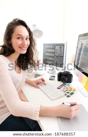 View of Young woman photographer processing pictures