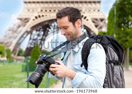 View of a Young attractive tourist taking pictures in Paris, France