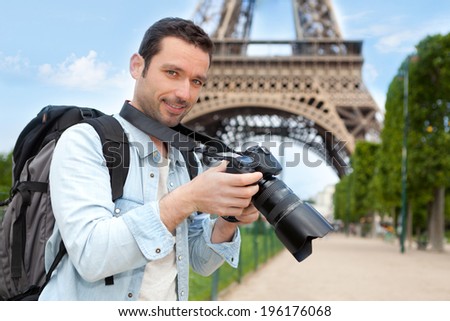 View of a Young attractive tourist taking pictures in Paris, France