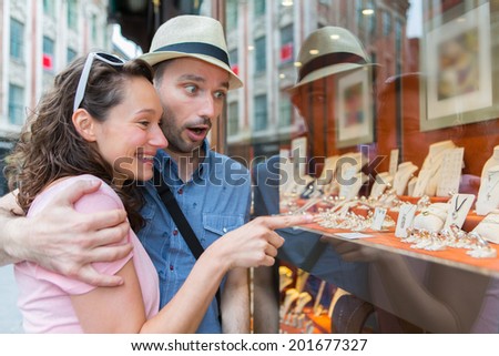 View of a Young couple in love watching jewelry store front