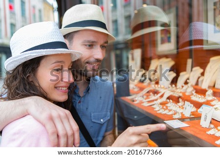 View of a Young couple in love watching jewelry store front